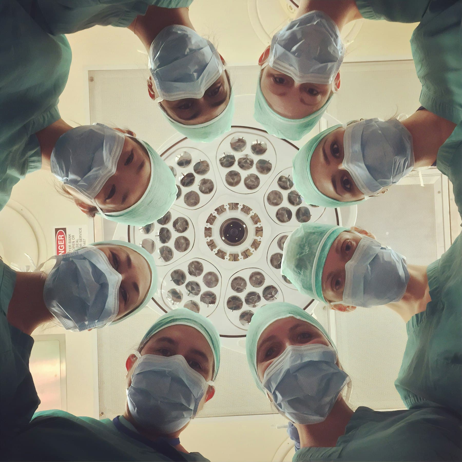 A surgical team working under lights in a sterile field
